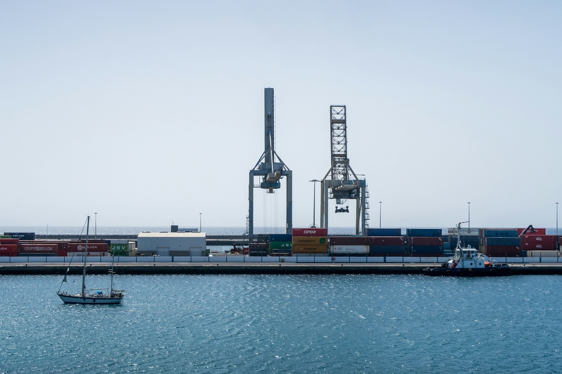 Industrial port with shipping containers and cargo cranes by the water