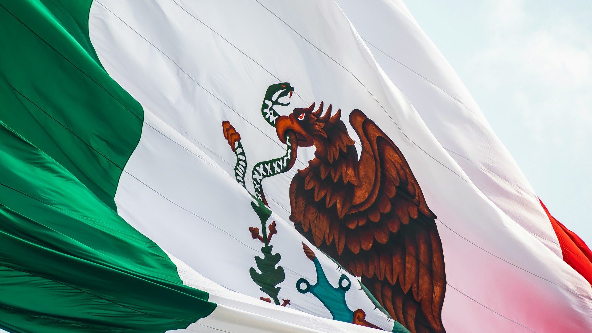 Bandera de México ondeando como contexto del análisis sobre verificación de fabricantes mexicanos