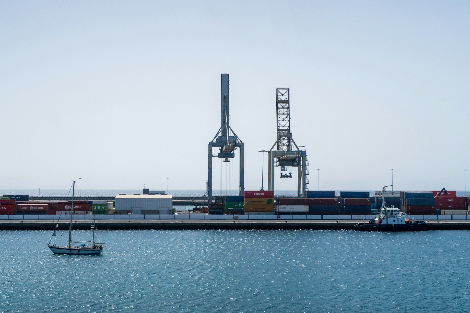 Industrial port with shipping containers and cargo cranes by the water
